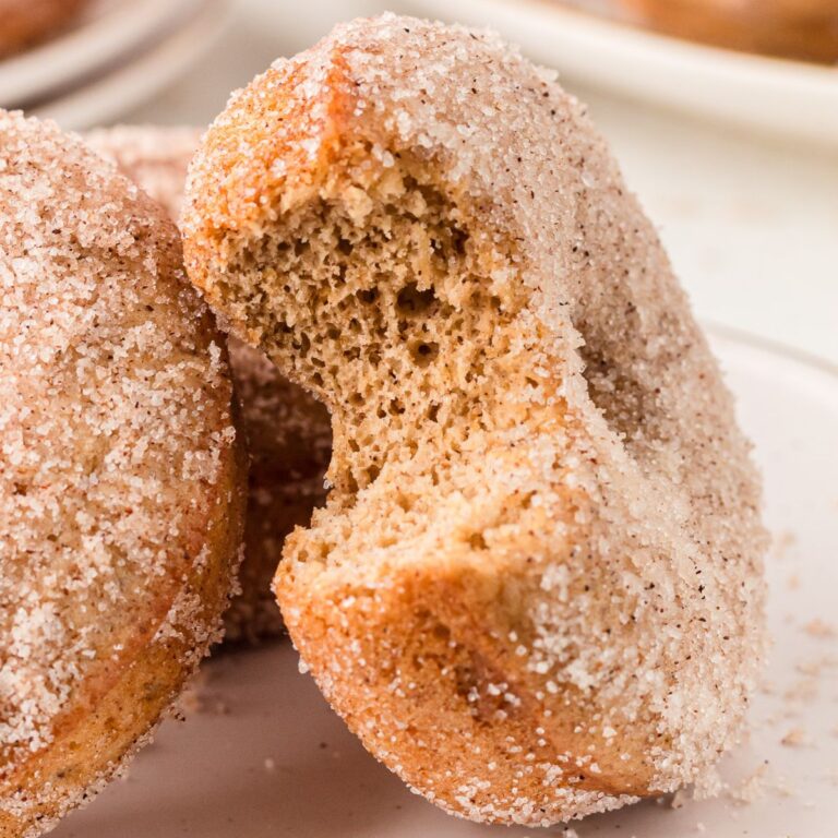 baked apple cider donut with a bite taken out